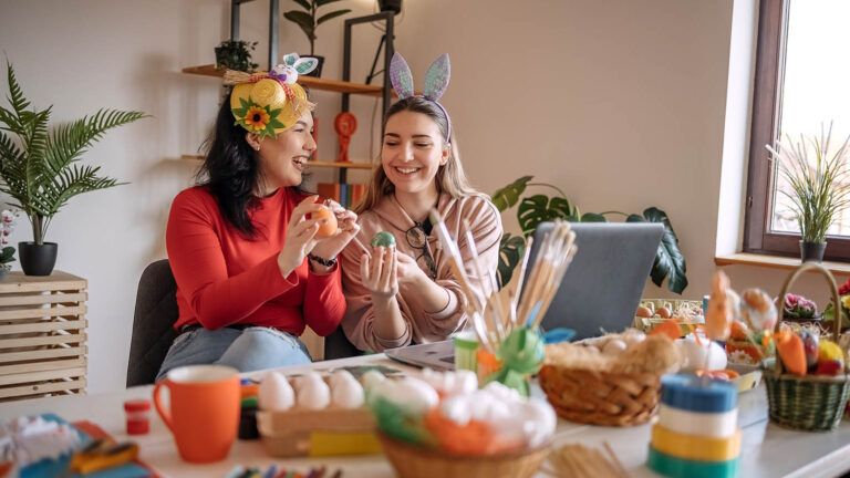 Two friends do an act of kindness by painting eggs and making Easter baskets