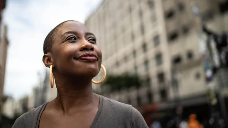 Woman looking up in a hopeful way during spring