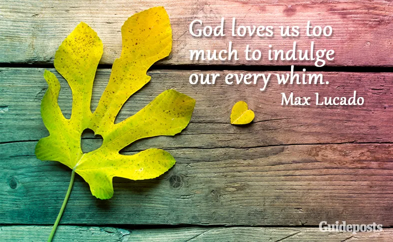 Leaf on a wood background with a heart cut out with a quote saying that God loves us too much to indulge our every whim.