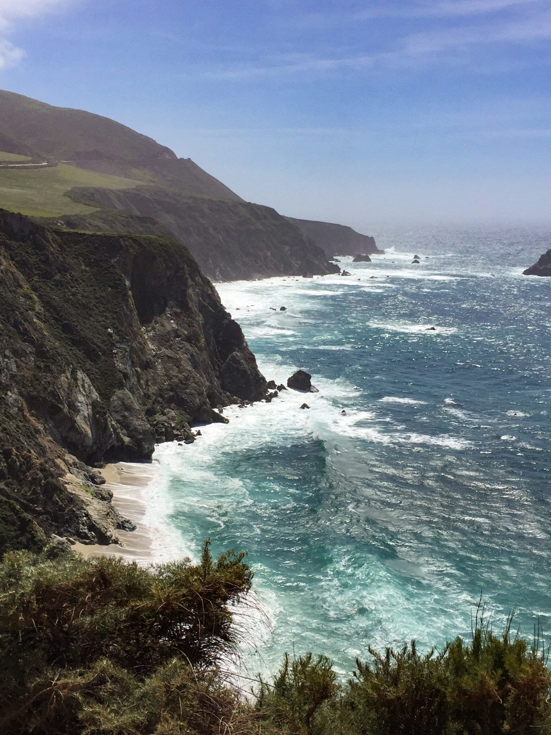 The surf pounds against the rising cliffs in Big Sur.