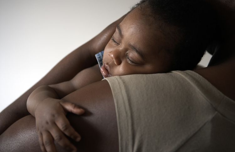Guideposts: A mother embraces her sleeping child