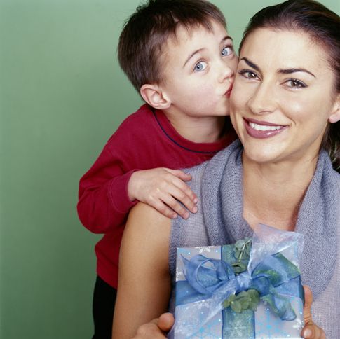 Guideposts: A young boy gives his smiling mother a smooch