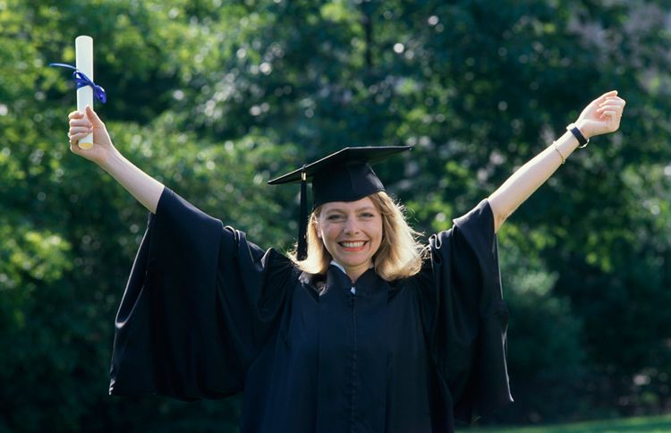 Guideposts: A woman graduating from college raises her arms in celebration