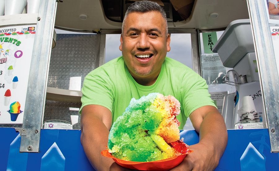 Alexx Nanez offers up one of his trademark shaved-ice cones.