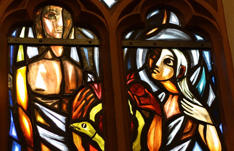 Adam and Eve depicted in stained glass