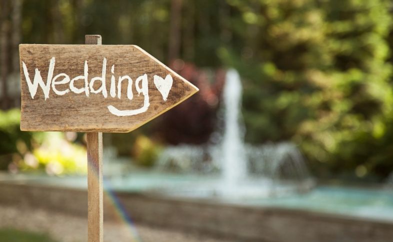 a wooden sign leading to wedding blessings