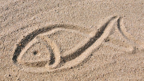 christian fish symbol in sand