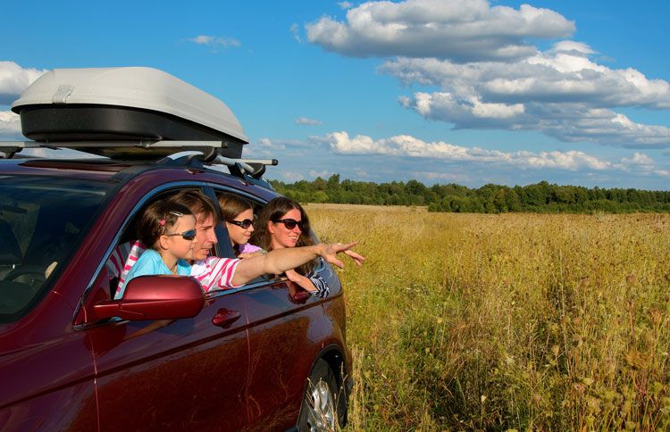 A family on a road trip gazes out to the horizon