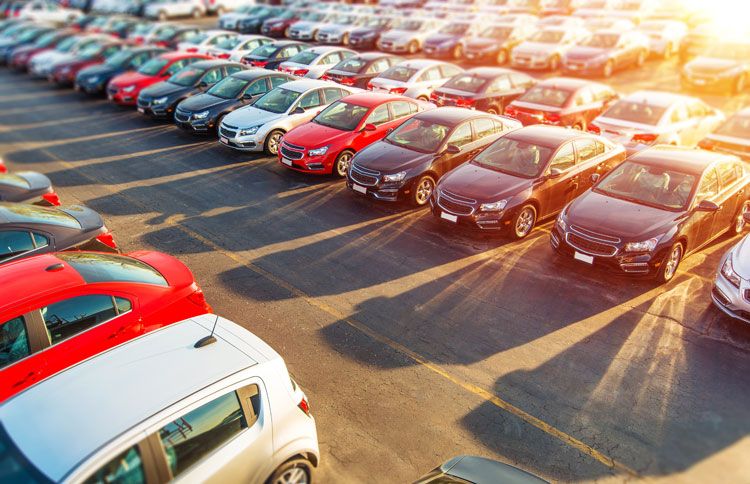New cars stretch as far as the eye can see on a automobile dealer's lot