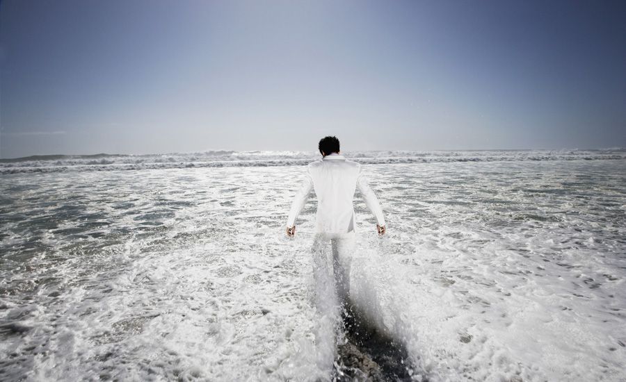 Man walking into the ocean