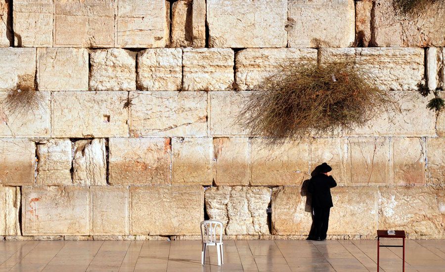 A person prays at the Western Wall