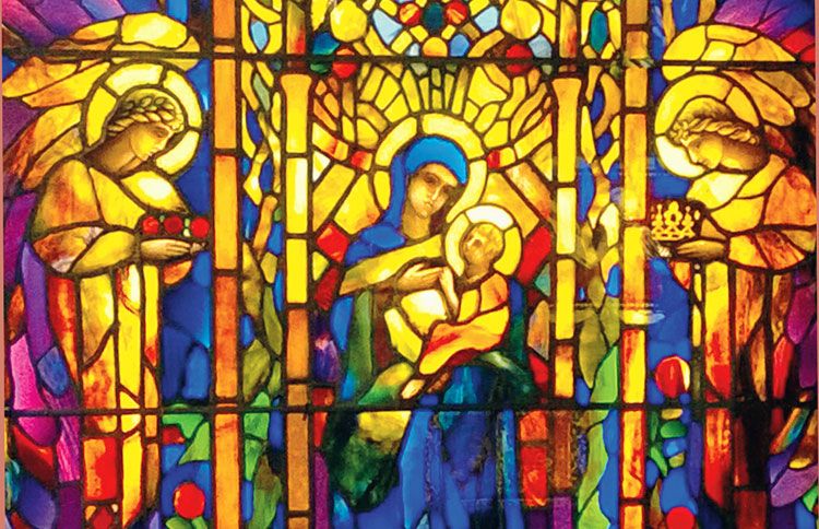 A photograph of Mary and Baby Jeus with a pair of angels taken at Smith Museum of Stained Glass Windows