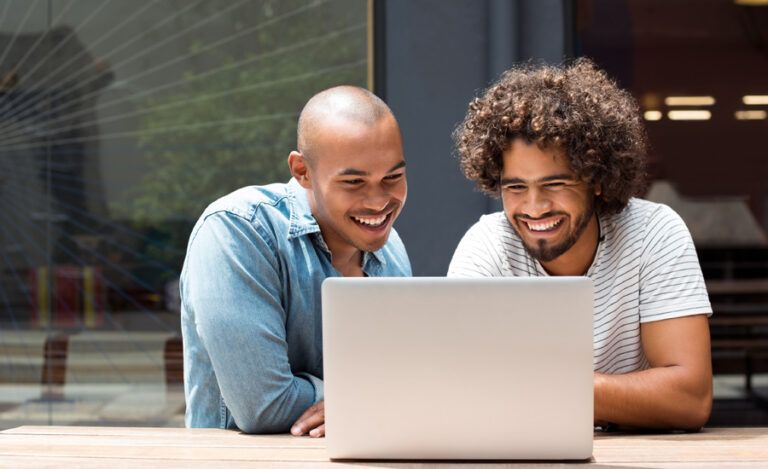 Two guys looking at a laptop