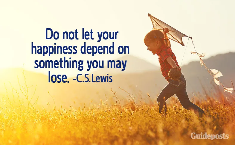 A child running through a field with a kite with C.S. Lewis quotes