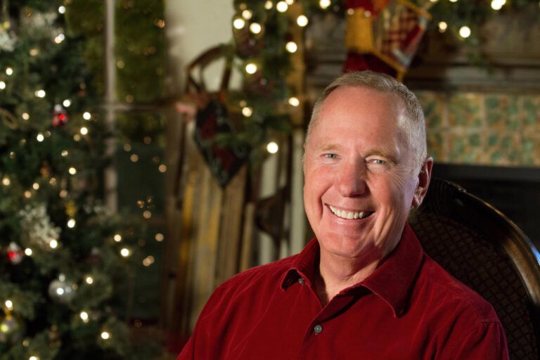 Max Lucado with a holiday decor background