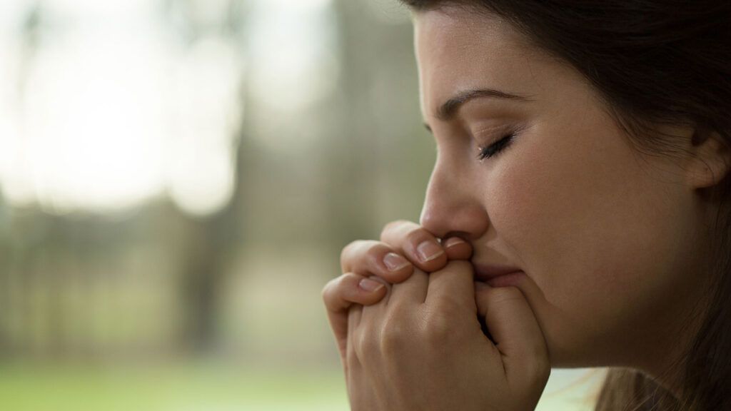 A woman fervently prays