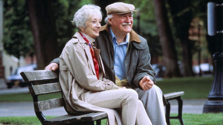 A mature couple enjoy an outing in the park.