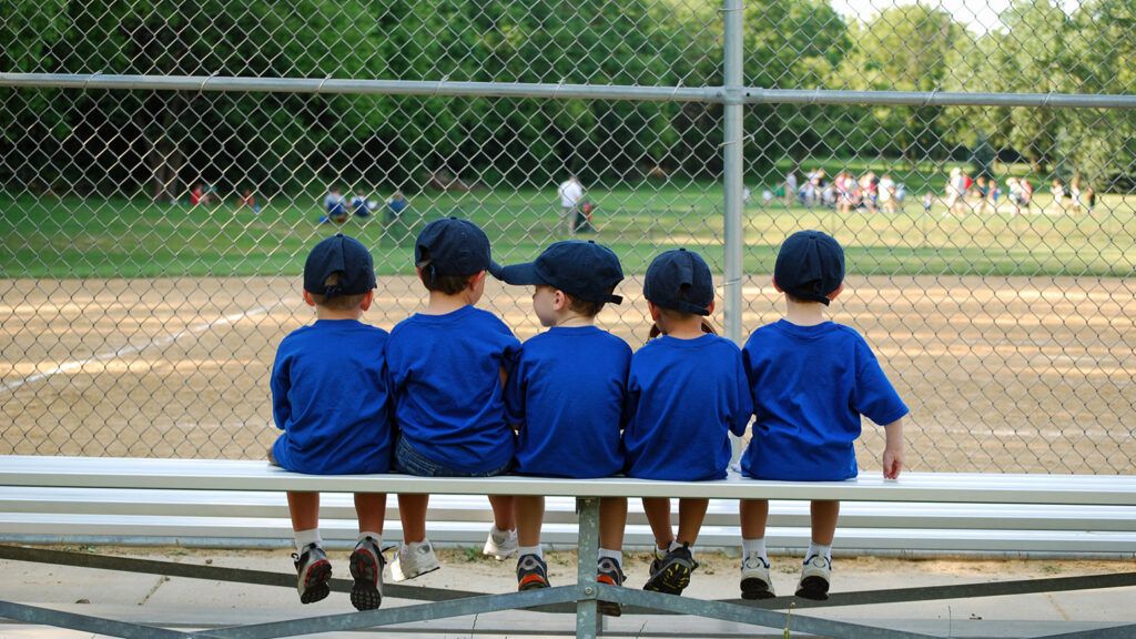 A quintet of Little Leaguers watch the action on the field