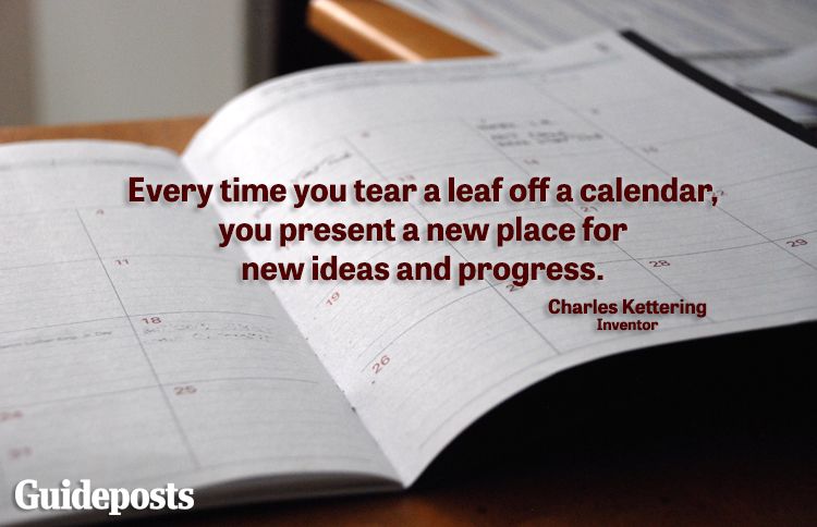 An open calendar planner with new year quote for progress