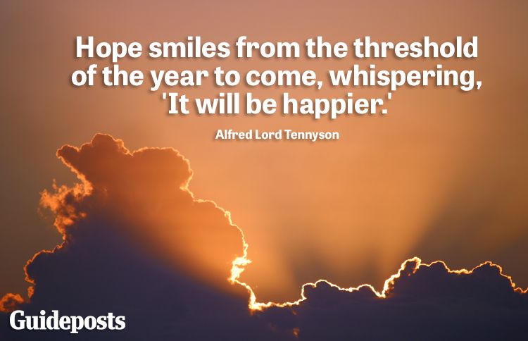 Sunlight peeking through a large cloud with new year quote about happiness