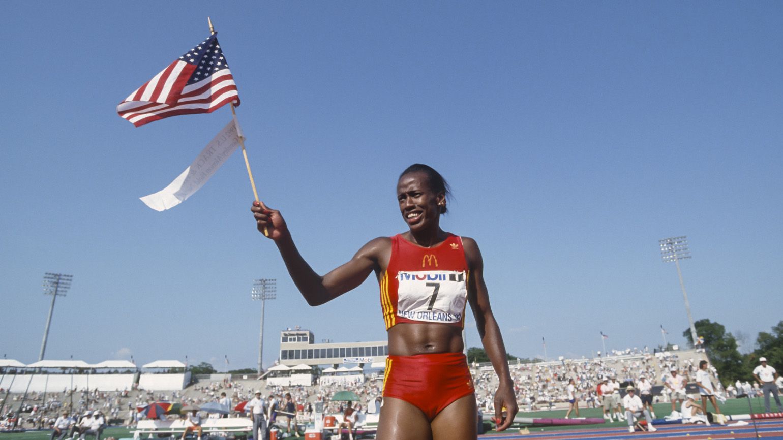 Jackie Joyner-Kersee walks with an American flag as an inspiring Black History Month figure