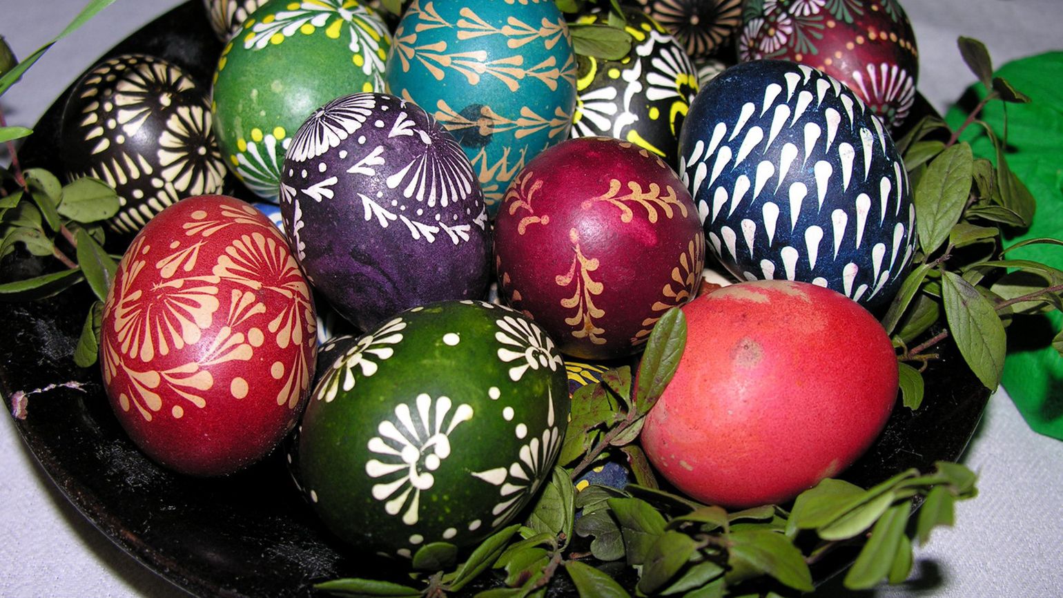 Colorfully dyed Easter eggs on a plate with various designs from Lithuania