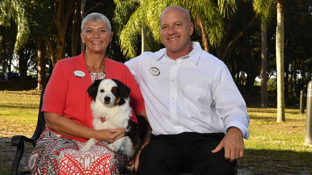 Jack relaxes with Laura Diachenko, his human, and Pastor Tom Hafer at the Gulf Coast Village in Cape Coral, Florida.