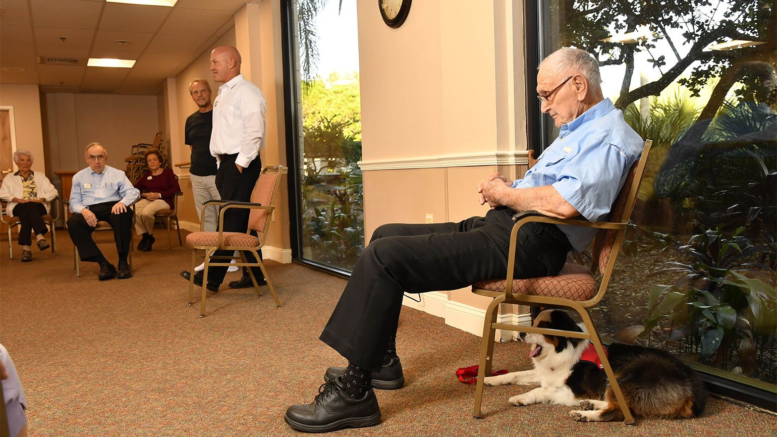 Jack and his handler, Roger Weiland, take a breather during a visit with a group of seniors participating in a Tai Chi class.