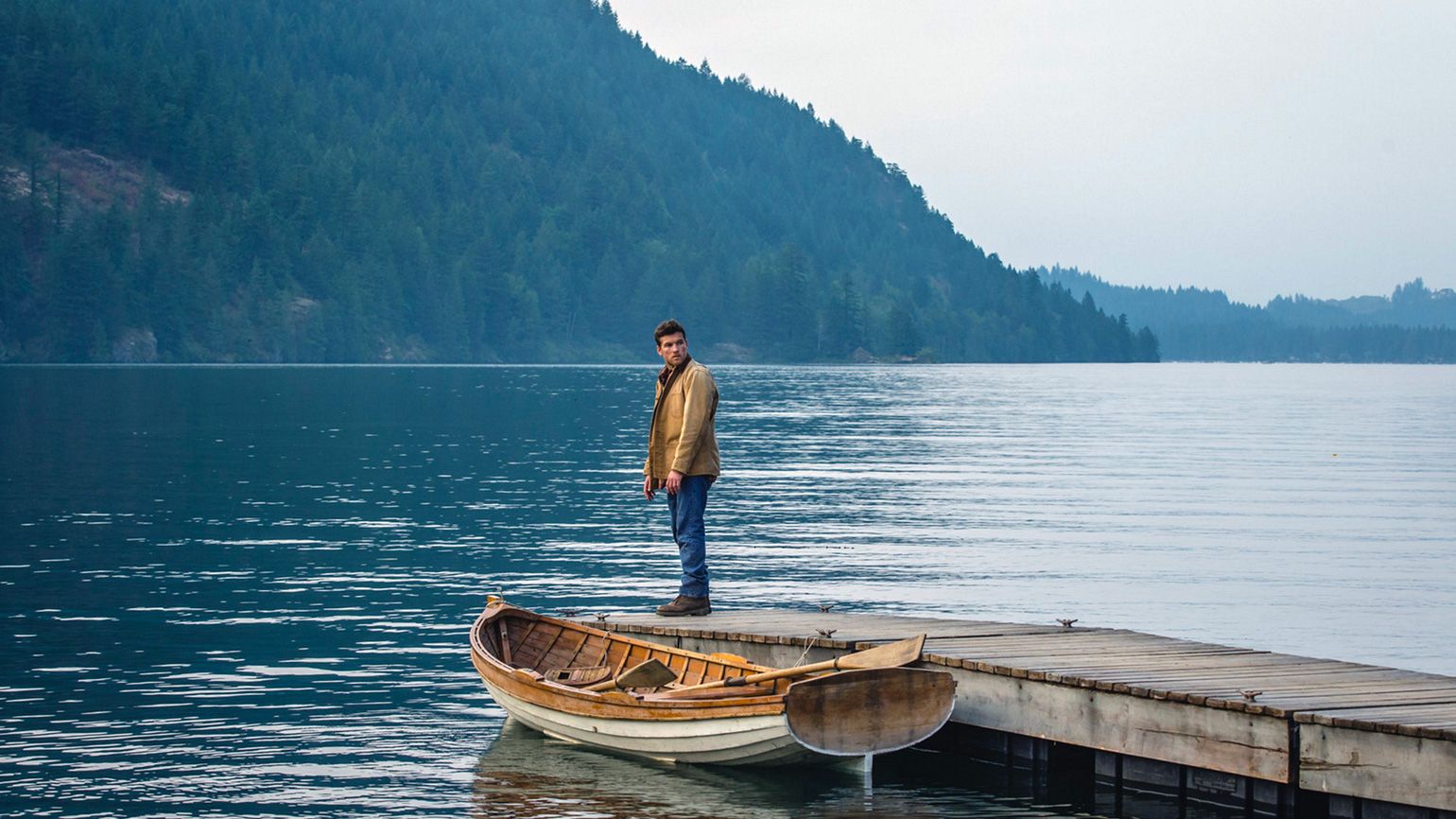 Sam Worthington as Mack Phillips gazes out at a mountain lake
