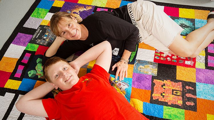 Lucas and Lisa Wasinger pose with their Minecraft quilt
