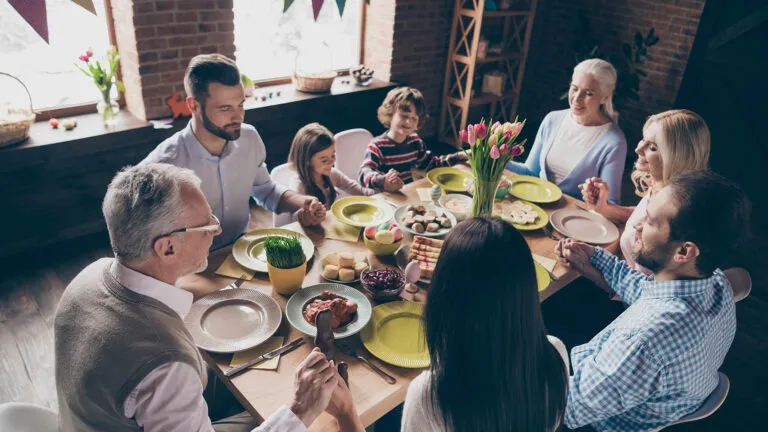 Family saying their holy week prayers together at the dinner table