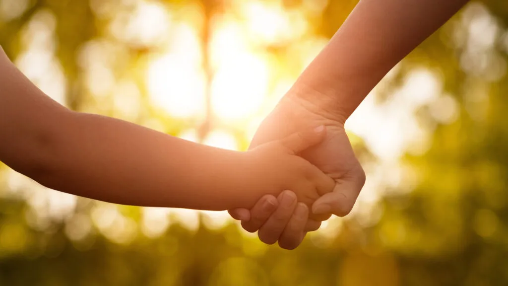 Mother holding hands with son