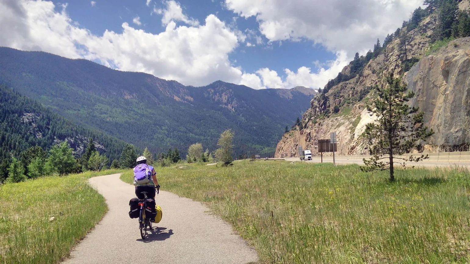 With the Rockie Mountains in the distance, Deborah continues her journey near Georgetown, Colorado