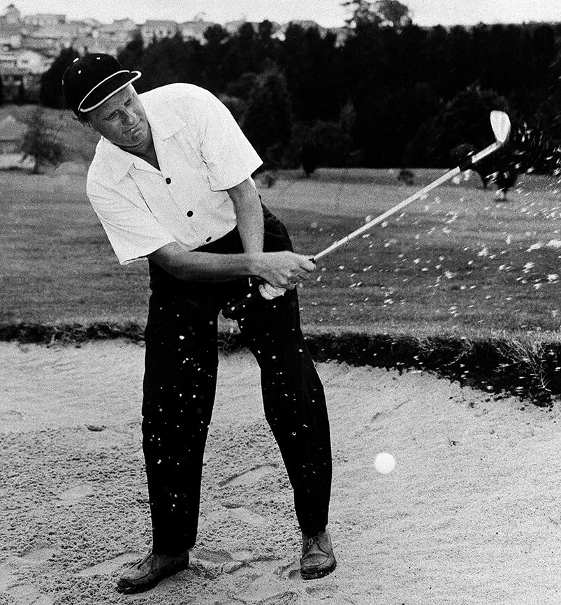 Graham blasts out of a sand trap on the Riversdale golf course in Victoria, Australia, on March 4, 1959.