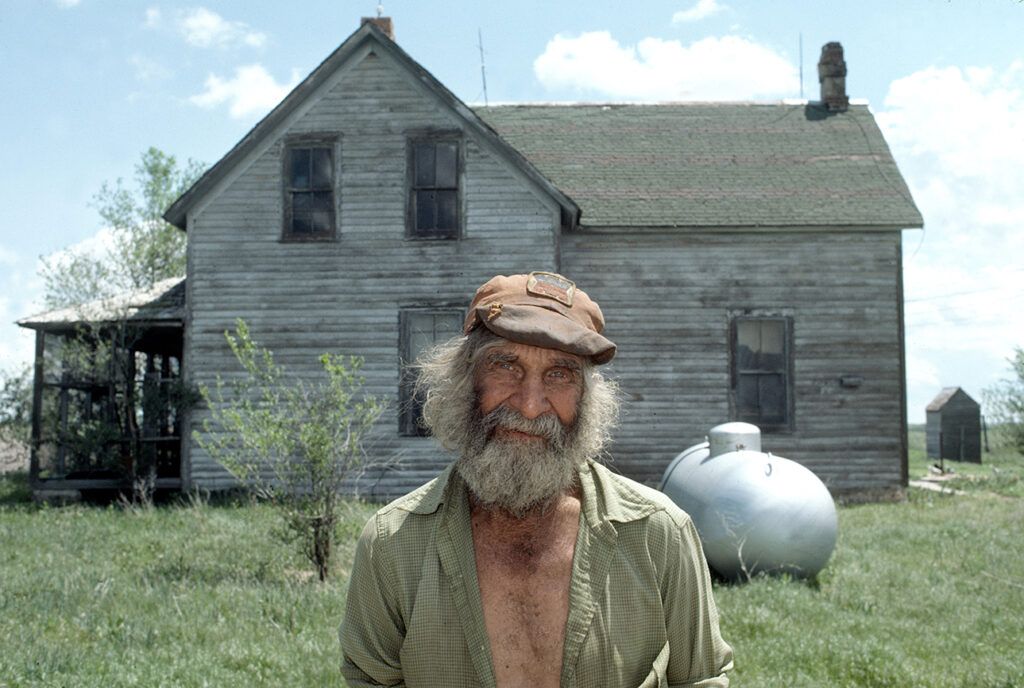 Farmer and folk artist Emery Blagdon outside his Nebraska home