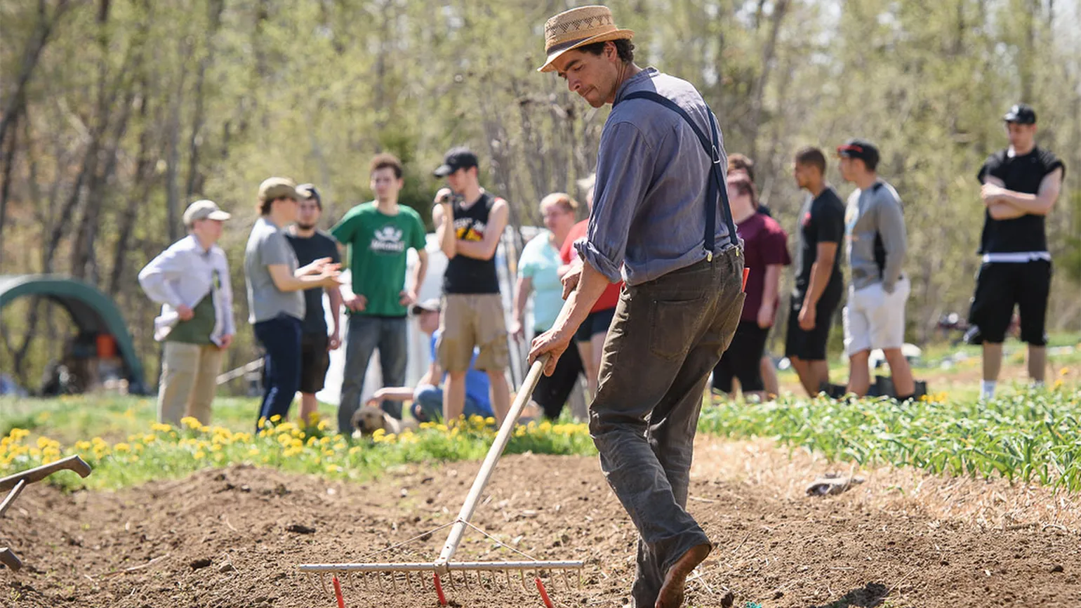 Michael hows the field as students look on