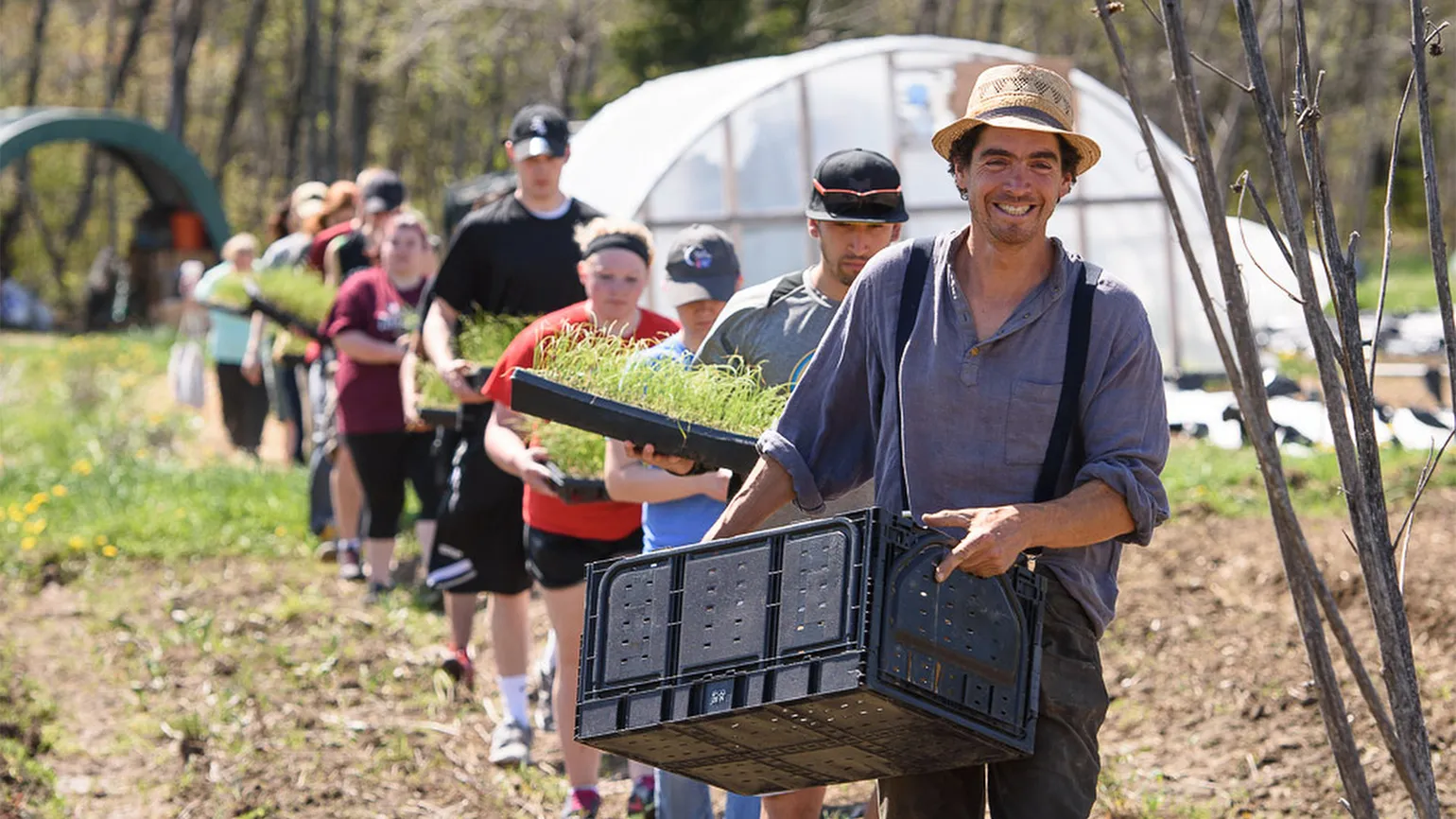 Students help Michael harvest his crops