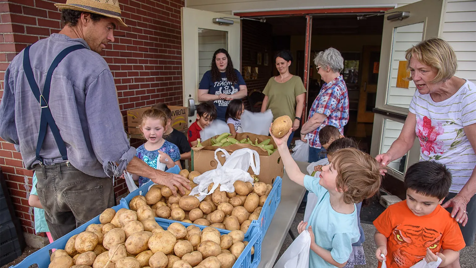 Michael helps students bag up their own produce