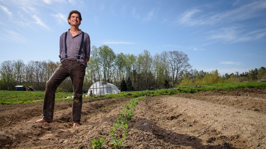 Michael Hayden stands in a field on his Maine farm