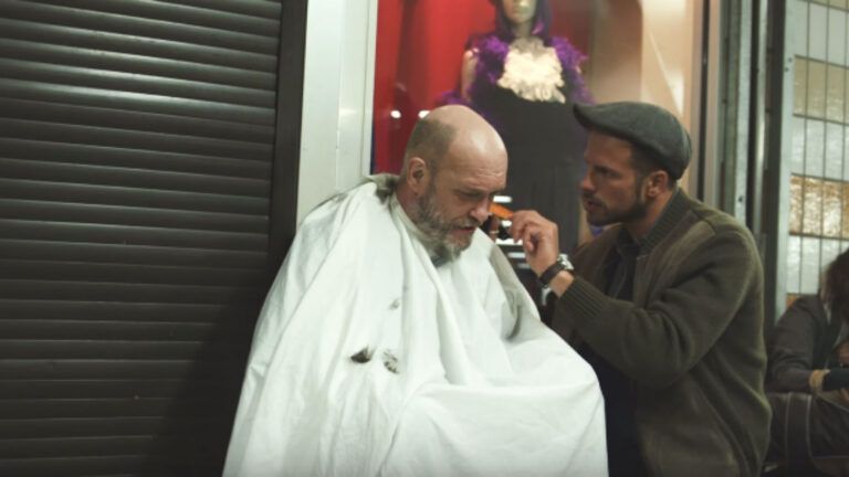 Joshua Coombes giving haircut to  homeless person