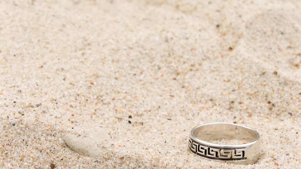A wedding band on the sand.