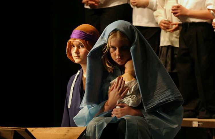 Two children portray Mary and Joseph in a church Christmas pageant