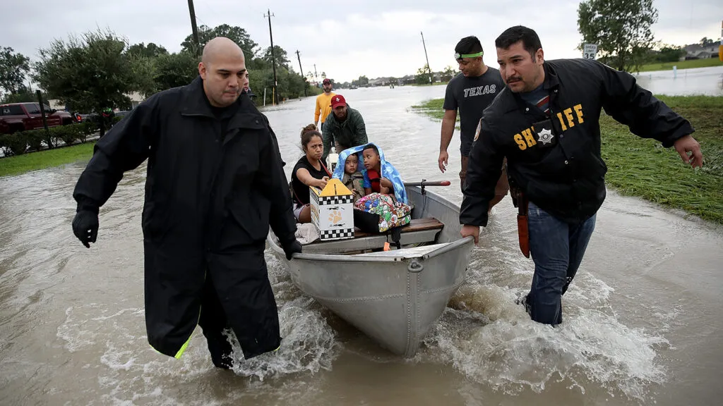 A family is evacuated from its home after severe flooding following Hurricane Harvey in north Houston