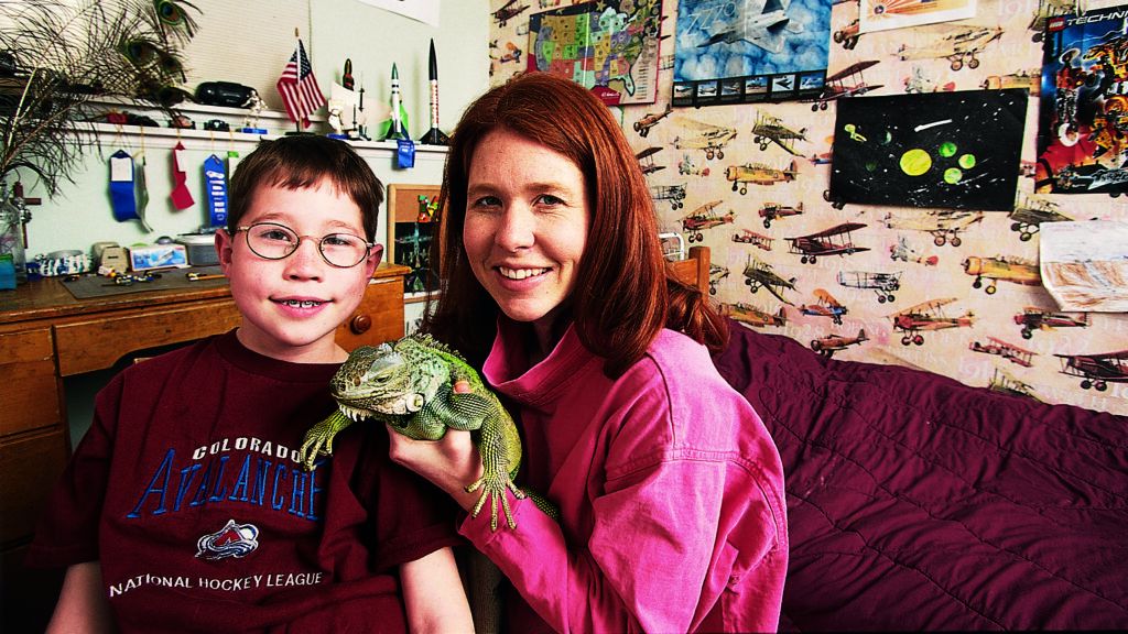 Max and his mother with his iguana, Bill in a no longer messy bedroom.