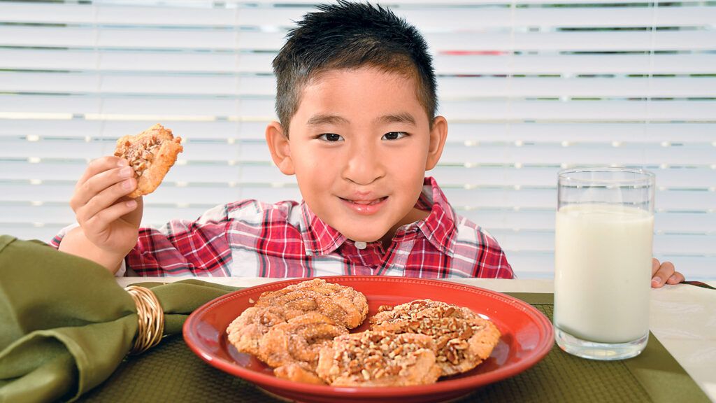 Becky's son Samuel smiles over a plate of the cinnamon crips that he helped to make