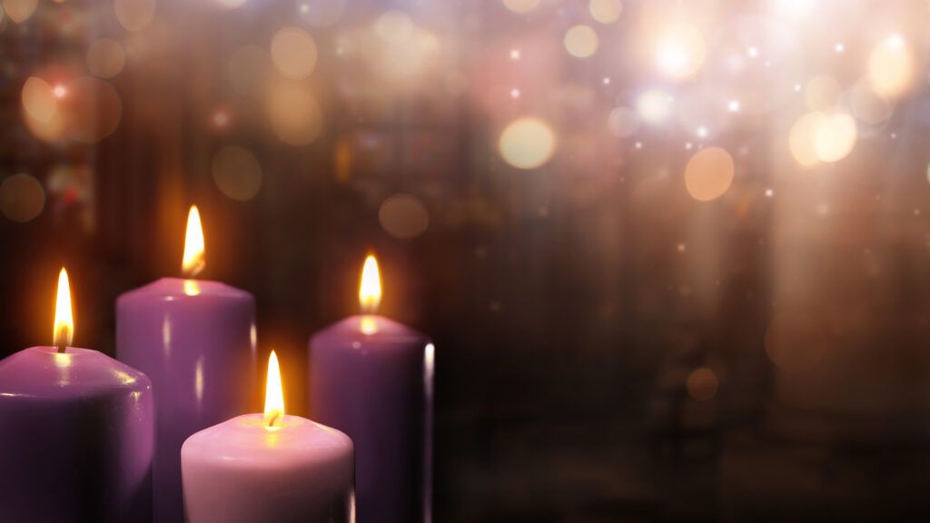A collection of purple Advent candles in a church with an Advent devotion