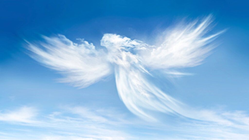 A cloud in the shape of an angel in a blue sky.