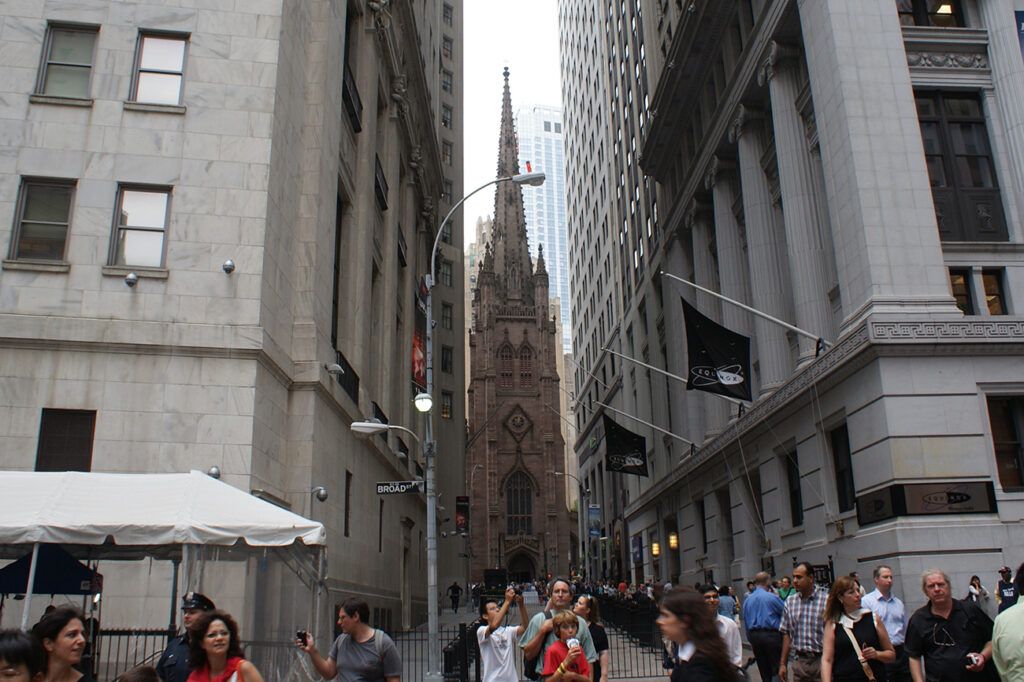 Trinity Church peeks out from between the office towers of Wall Street