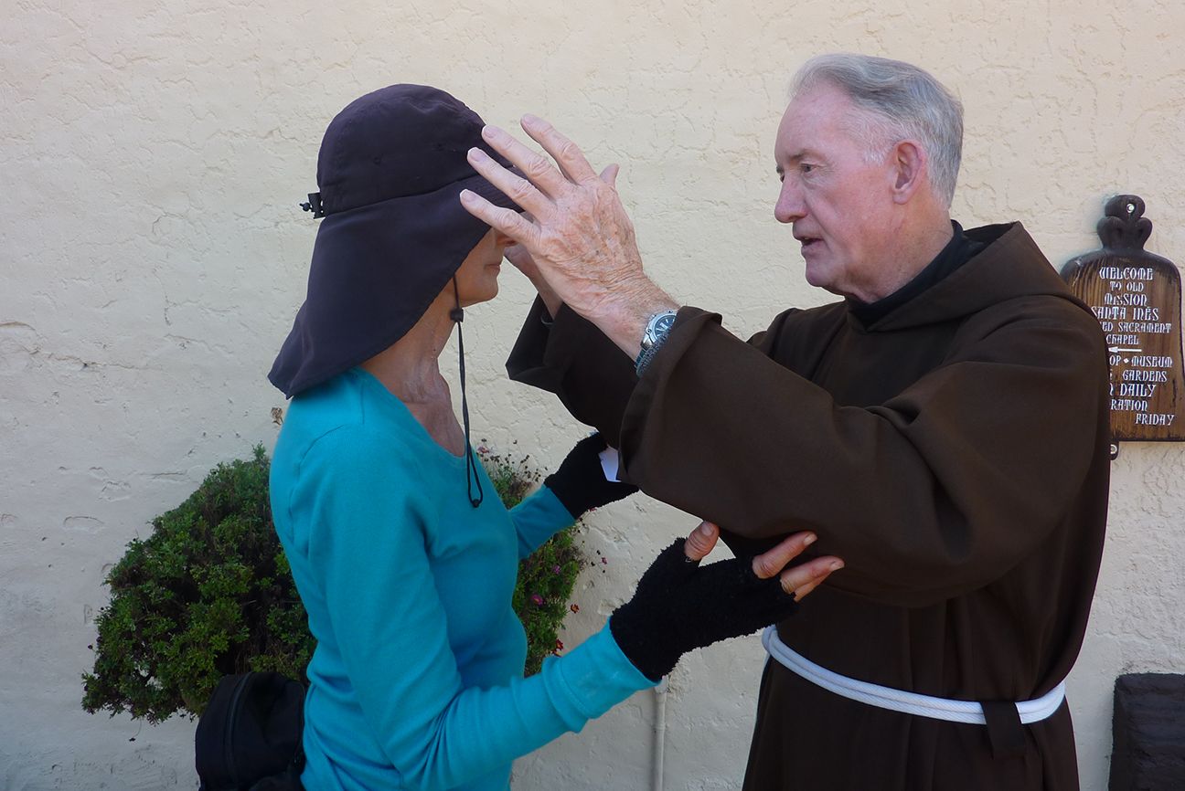 Day 21: Edie receives a blessing from Father Gerald Barron at Mission Santa Ines.