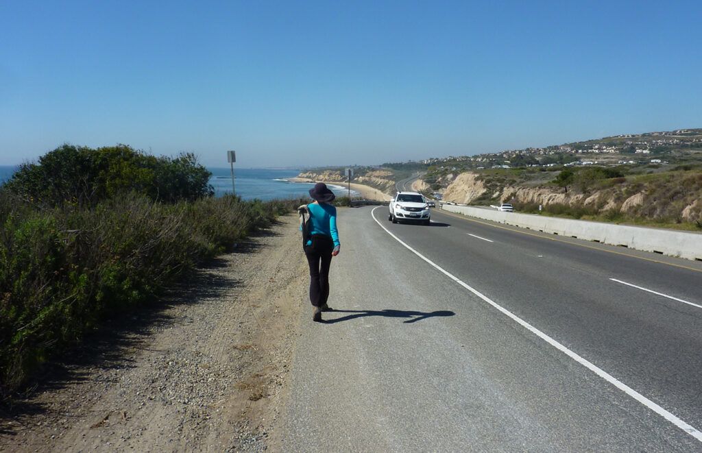 Day 7: Edie walking along Pacific Coast Highway out of Laguna Beach toward Newport, California